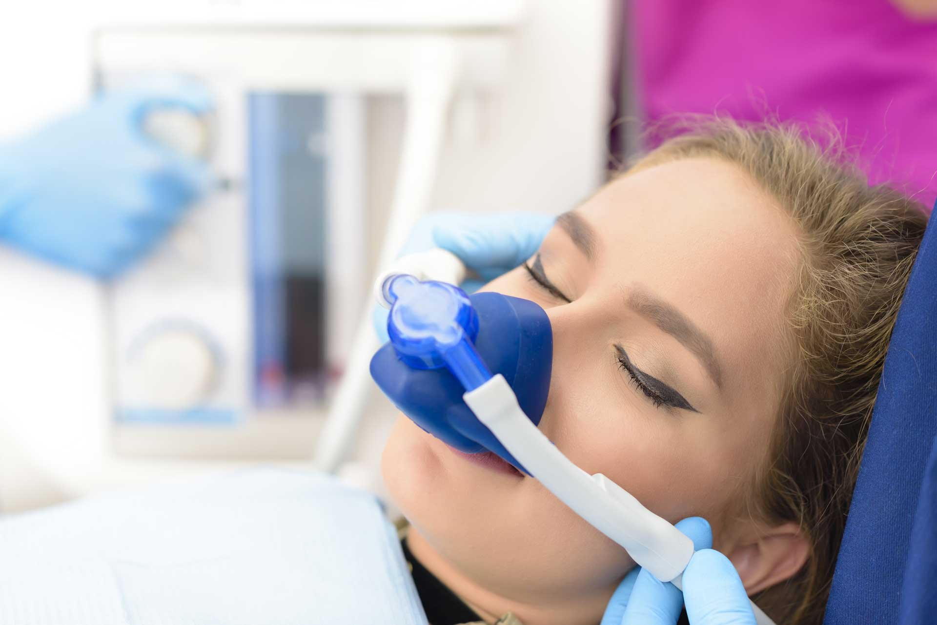 Woman getting inhalation sedation at dental clinic