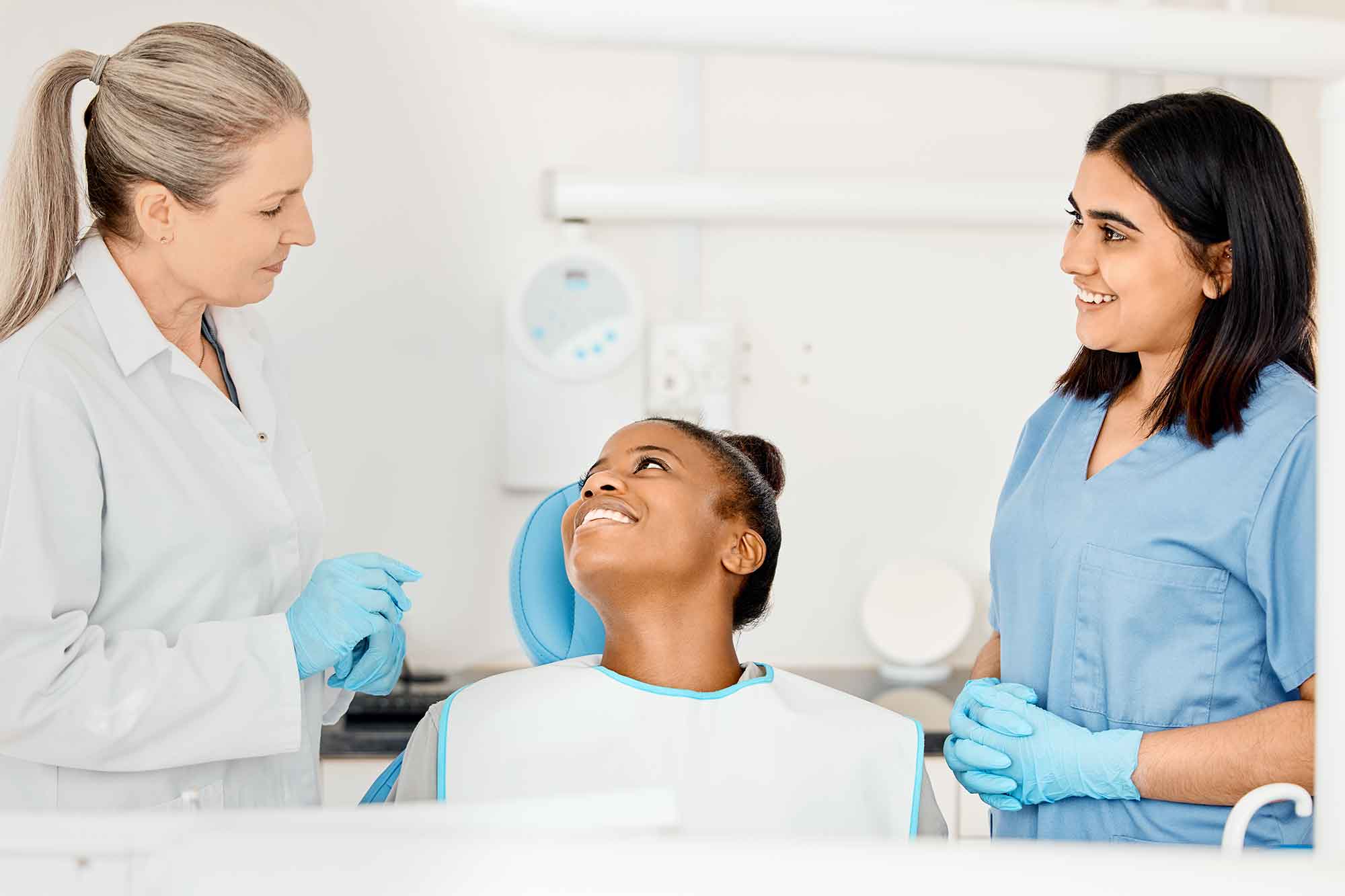 Shot-of-a-dentist-and-her-nurse-treating-a-patient