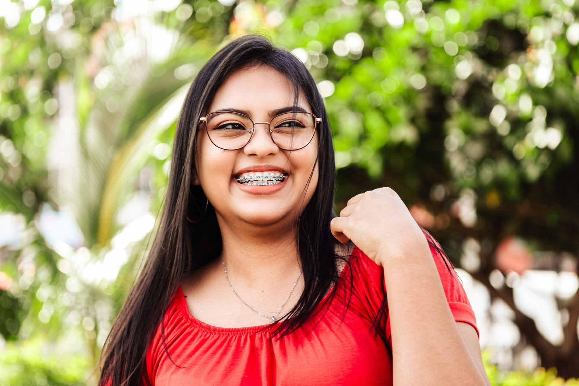 smiling-hispanic-girl-with-braces-and-red-shirt