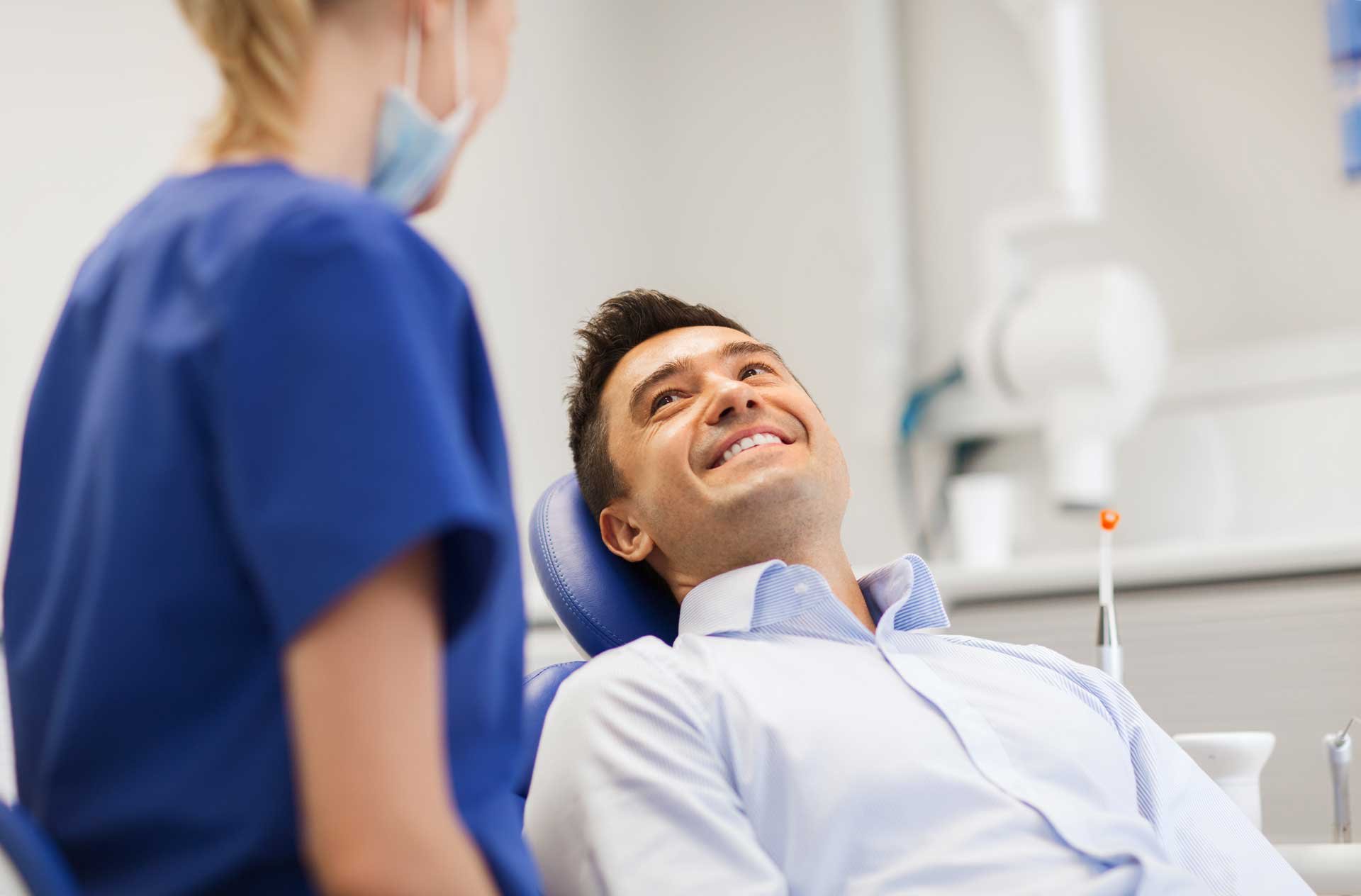 smiling-male-dentist-chair-dark-hair