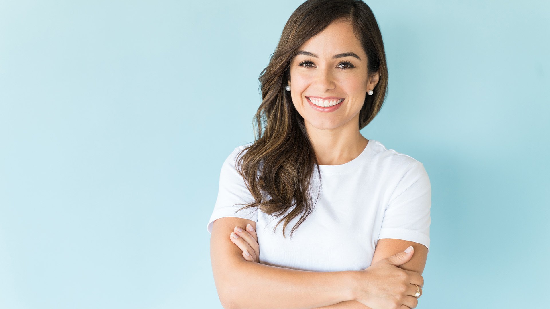 Inage of a brown haired woman in a white tshirt, smiling at the camera 