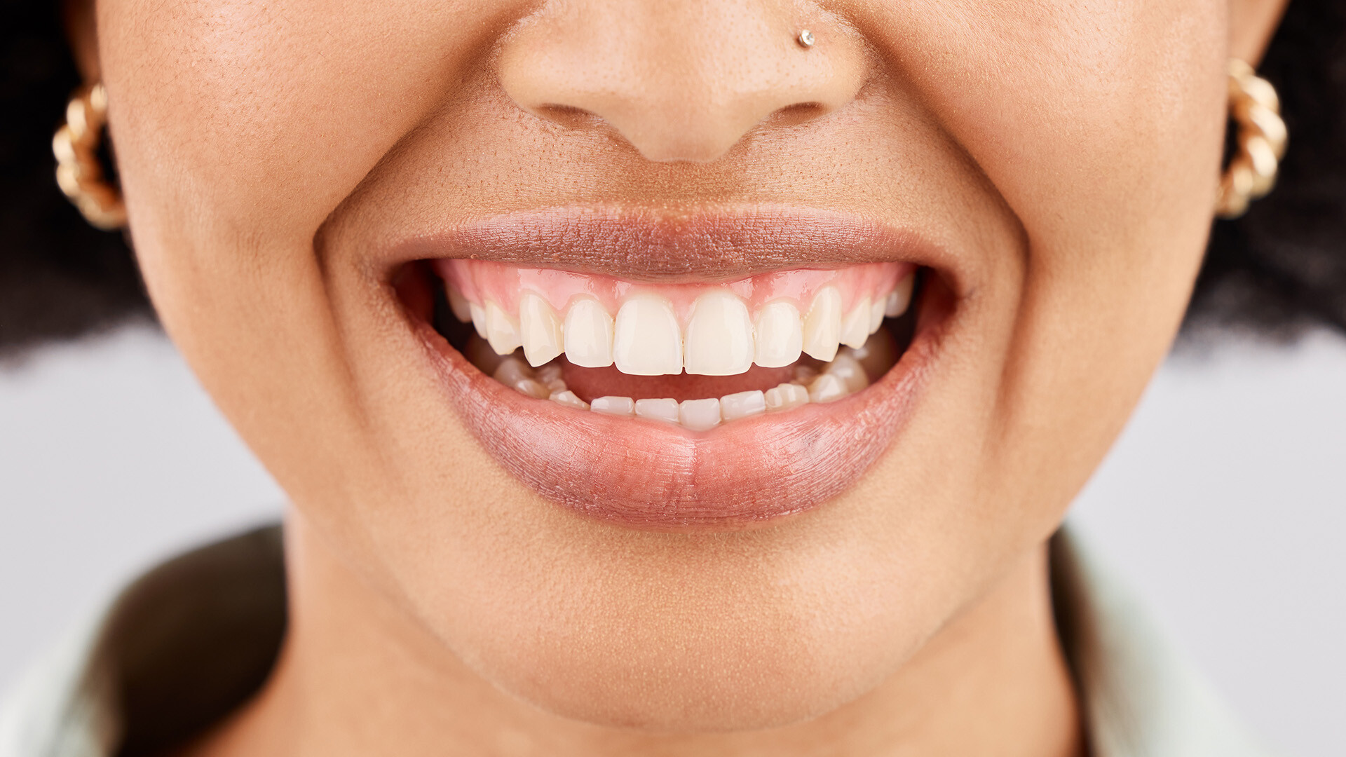 Close up shot of a smiling woman with very clean teeth and gums 